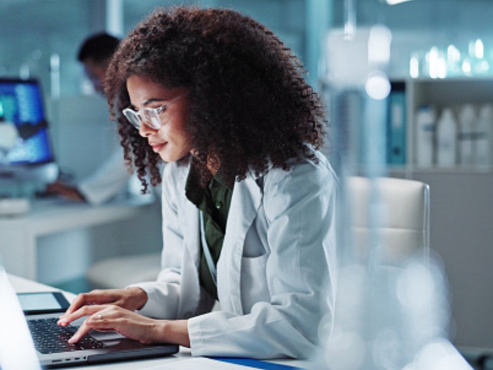 Woman. laptop and lab for research science or online internet for futuristic discovery, microscope or medicine. Female person, brainstorming and biotechnology for investigation, cure or development